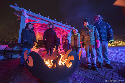 Visitors gather around a campfire during Night Lights.